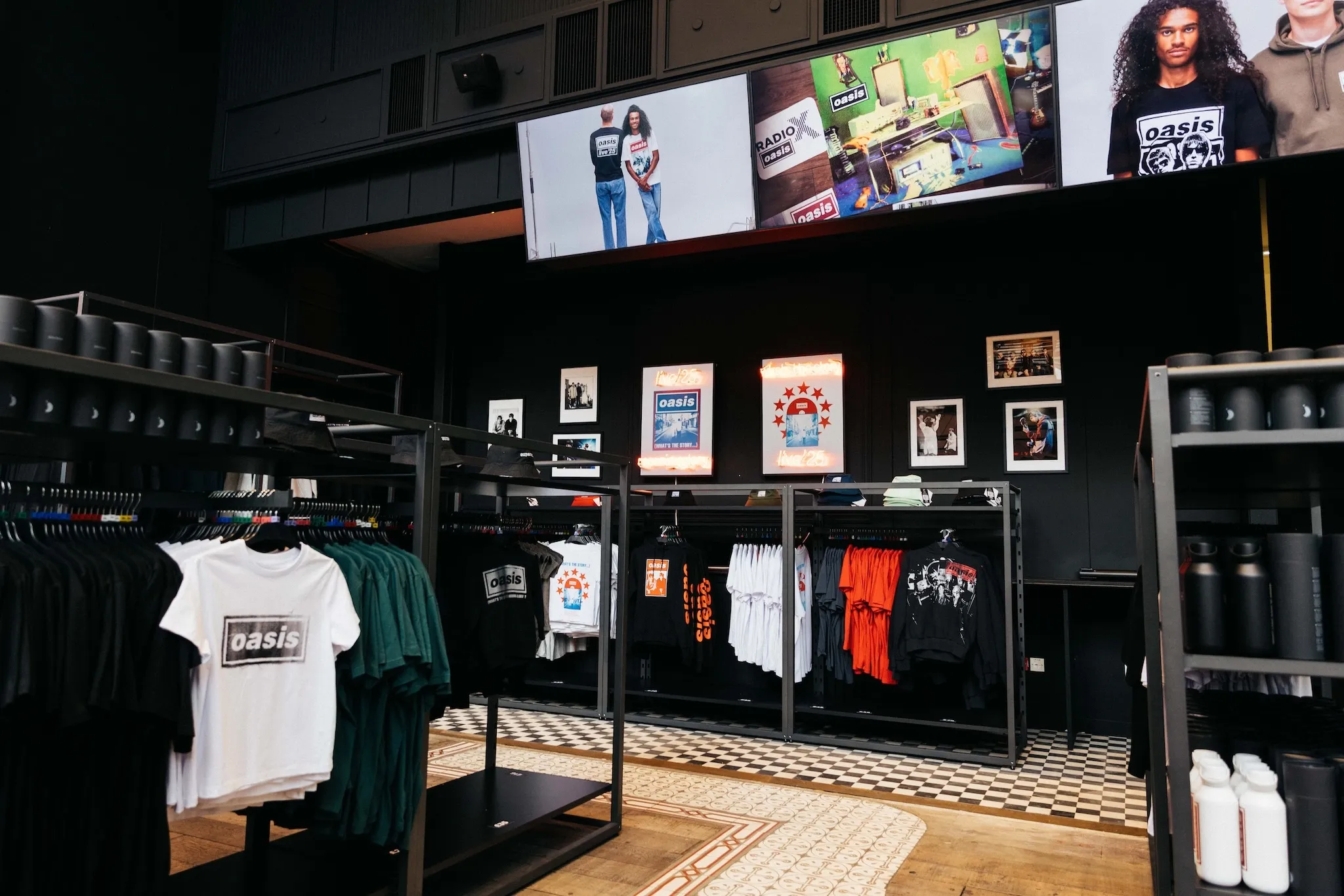 A picture of the Oasis Live '25 pop-up shop, including t-shirts, posters and vinyl records.