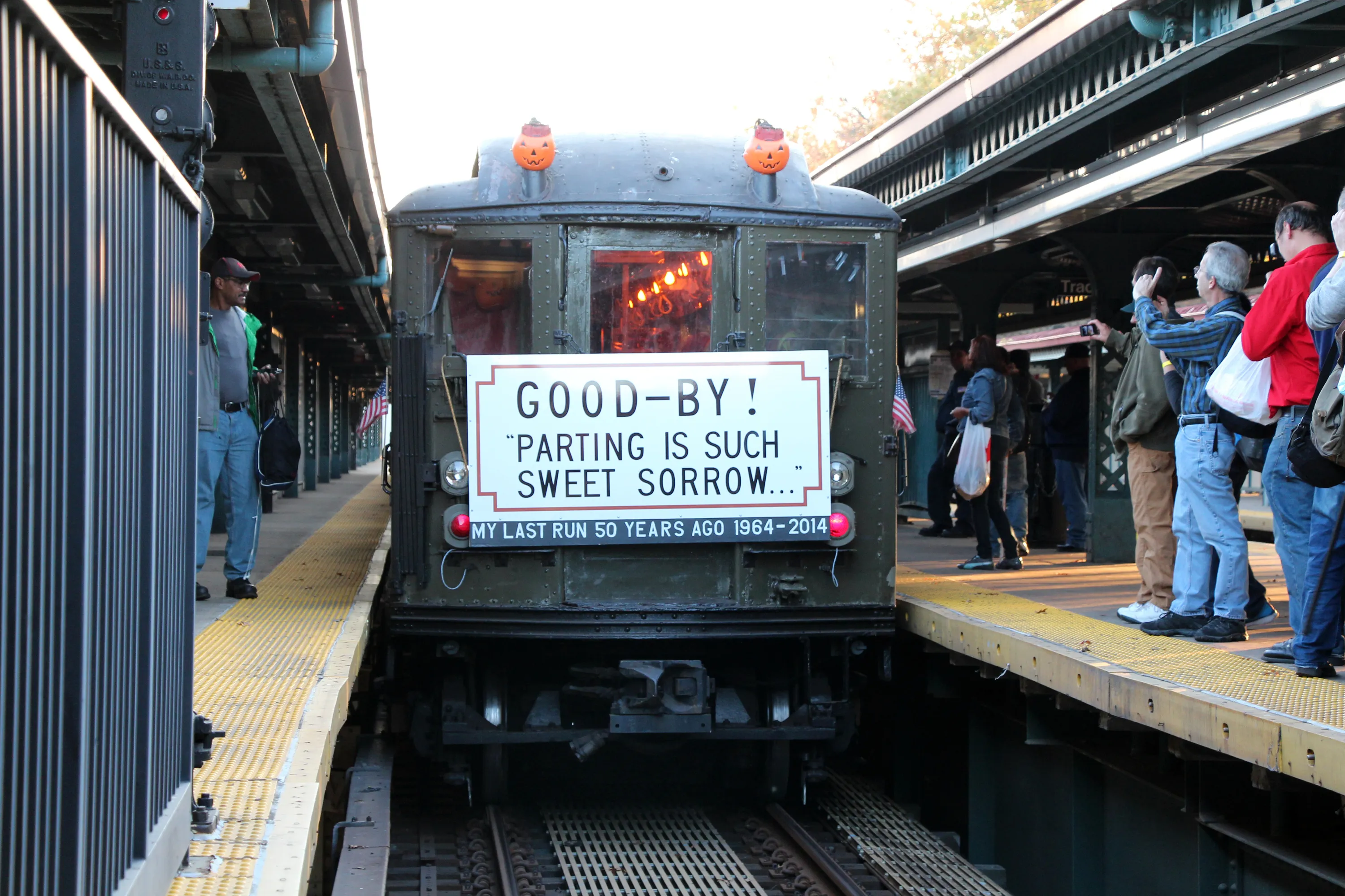 A vintage NYC train car pulling into a station