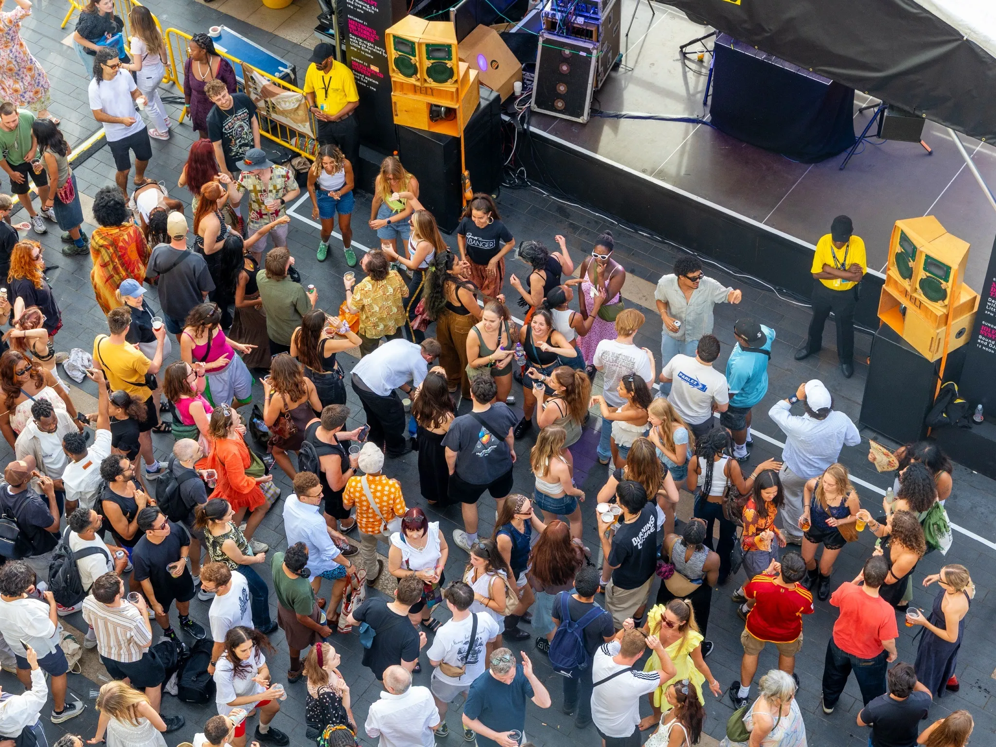 Aerial shot of a crowd of dancers in front of loudspeakers on the Southbank Centre River Terrace