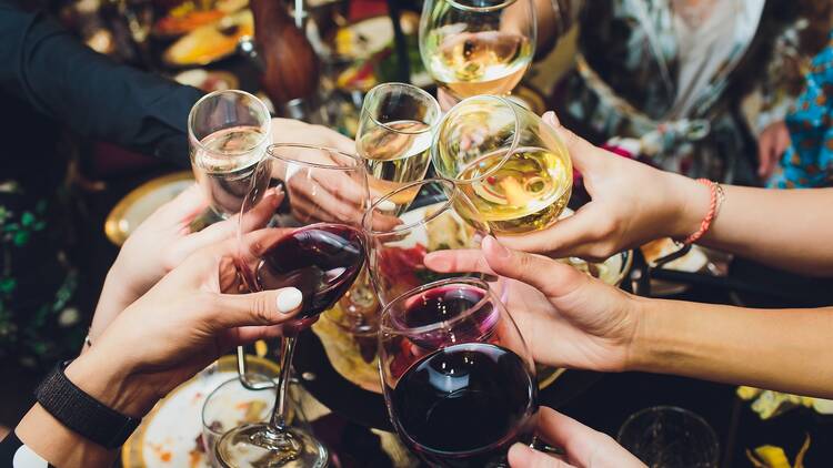 Group of people clinking glasses of wine