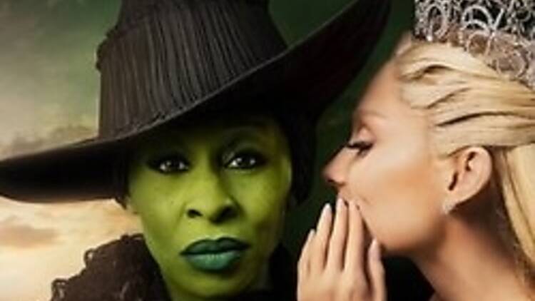 a woman whispering into another woman's ear a woman whispering into another woman's ear
