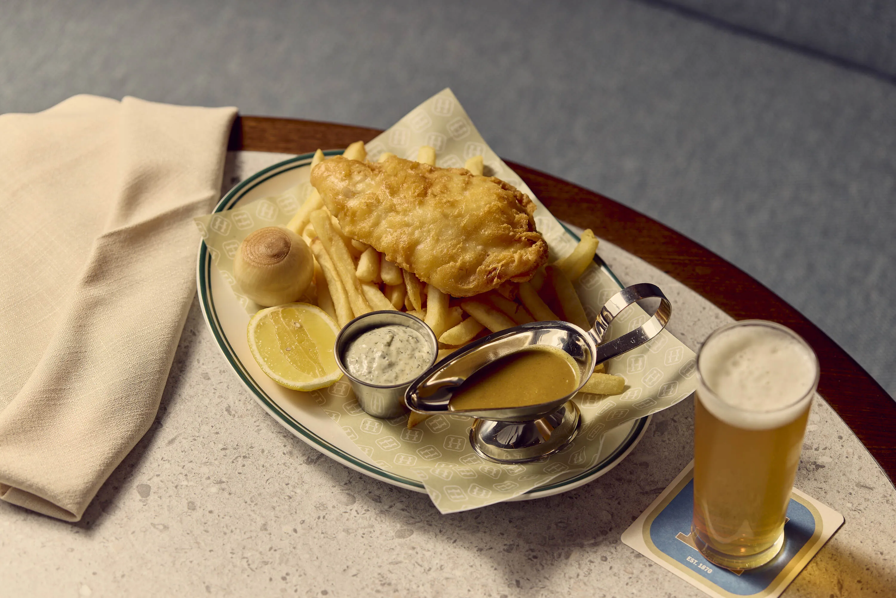 Fish and chips on a table at Hickens Hotel.