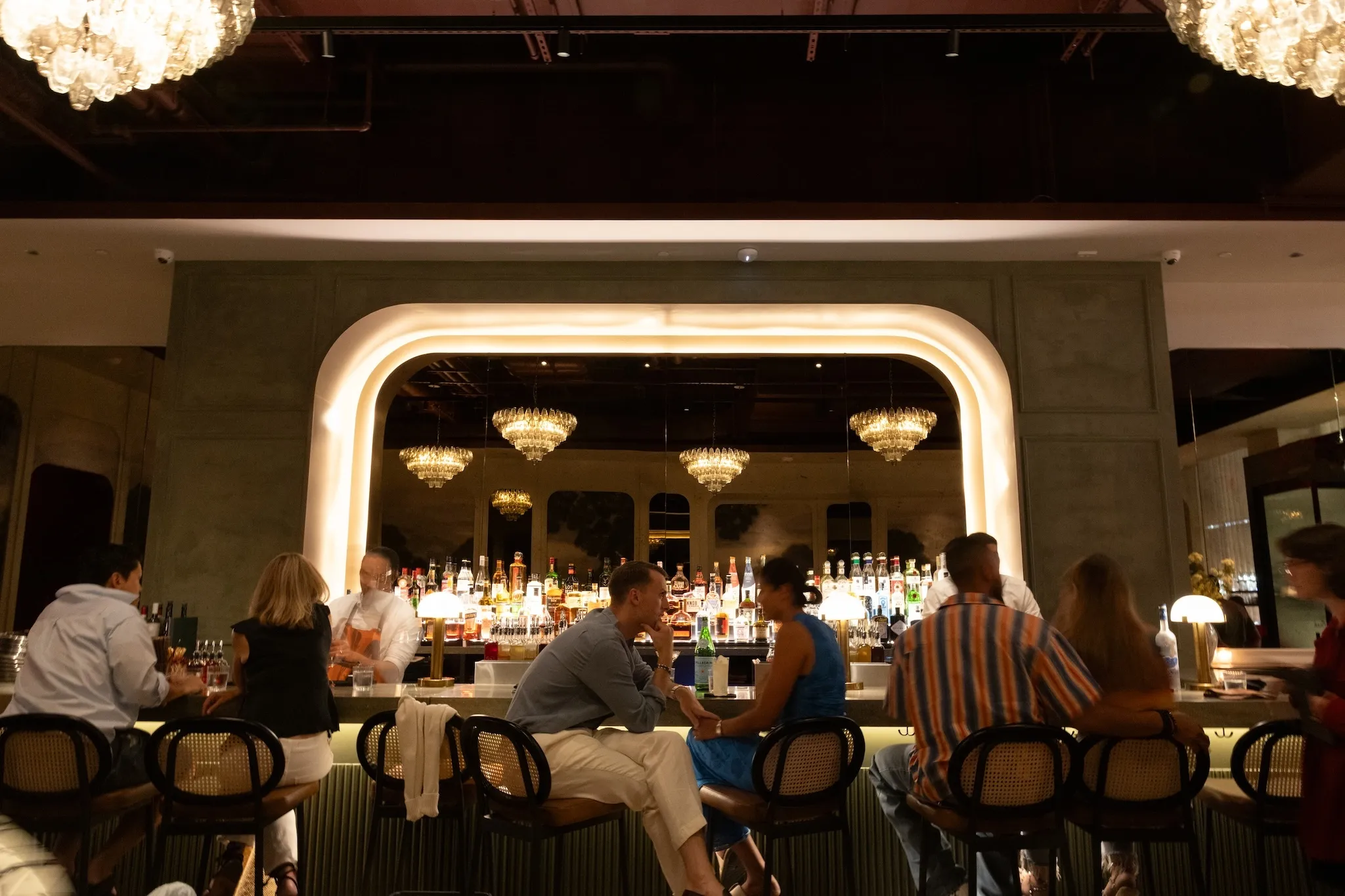 A huge illuminated mirror sits behind the bar at Markette