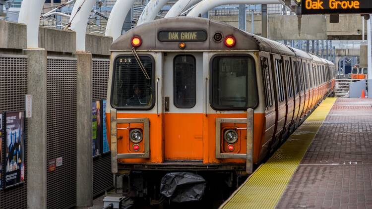 Orange line arriving in at an MBTA station