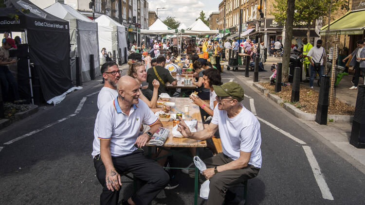 People eating at tables on Chatsworth Road 