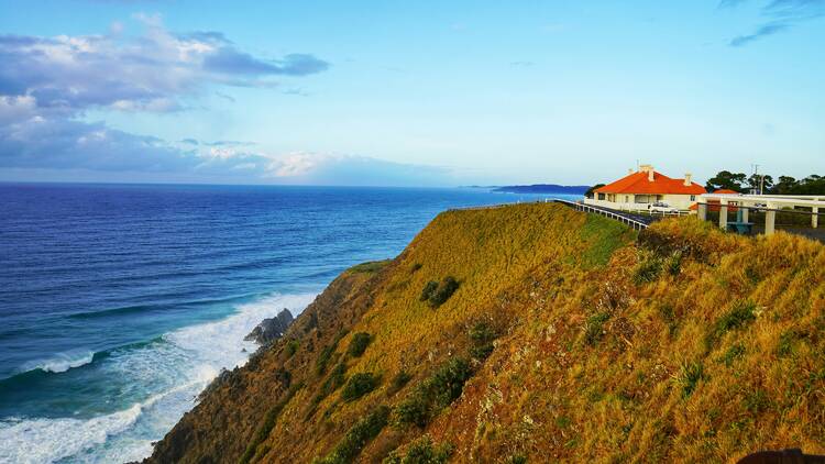 a building on a hill by the ocean
