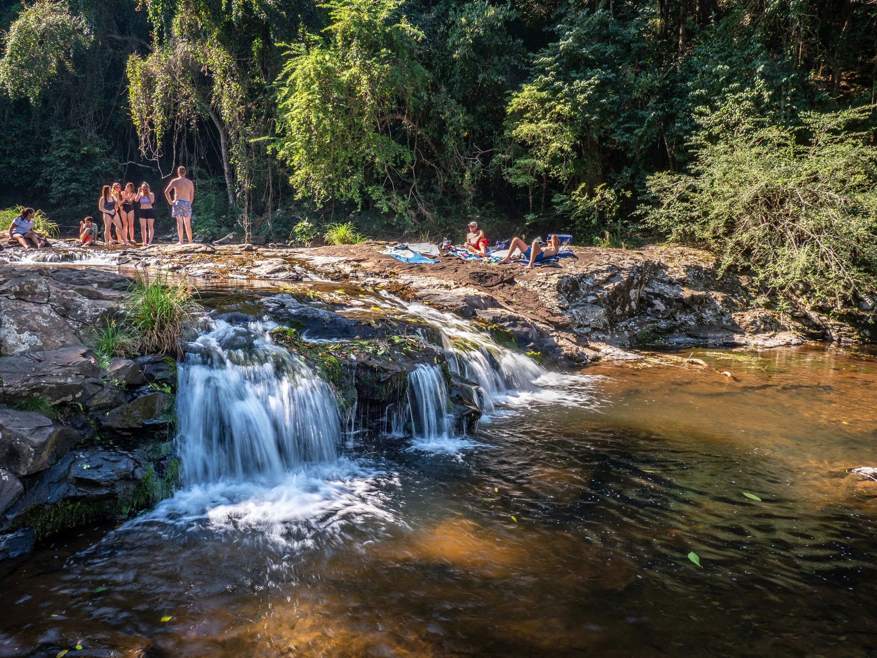 Waterfall with swimmers