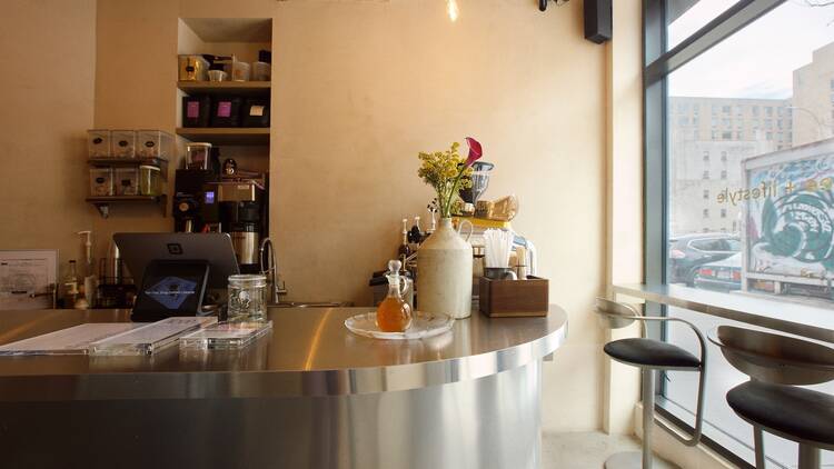 A silver coffee counter near a large window