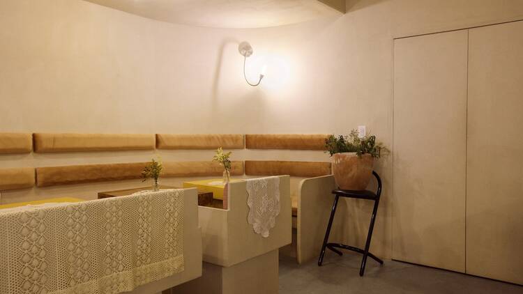A Backroom at The Oma Shop II with yellow velvet seats and doilies 