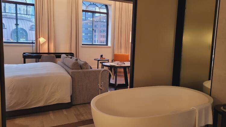 A beautiful hotel room with a deep bathtub