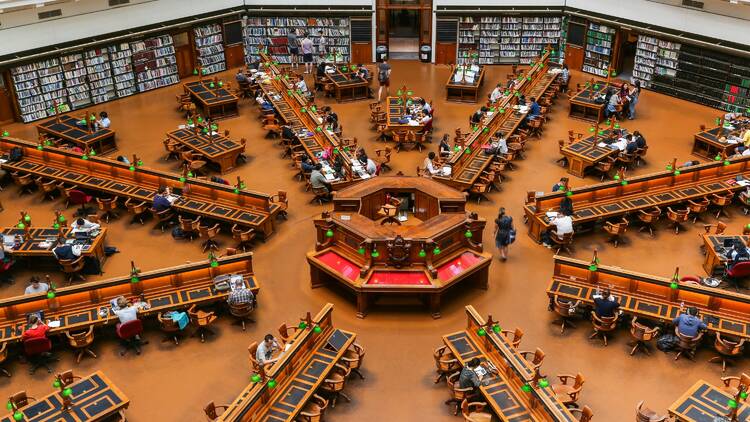 People sitting on chairs in library