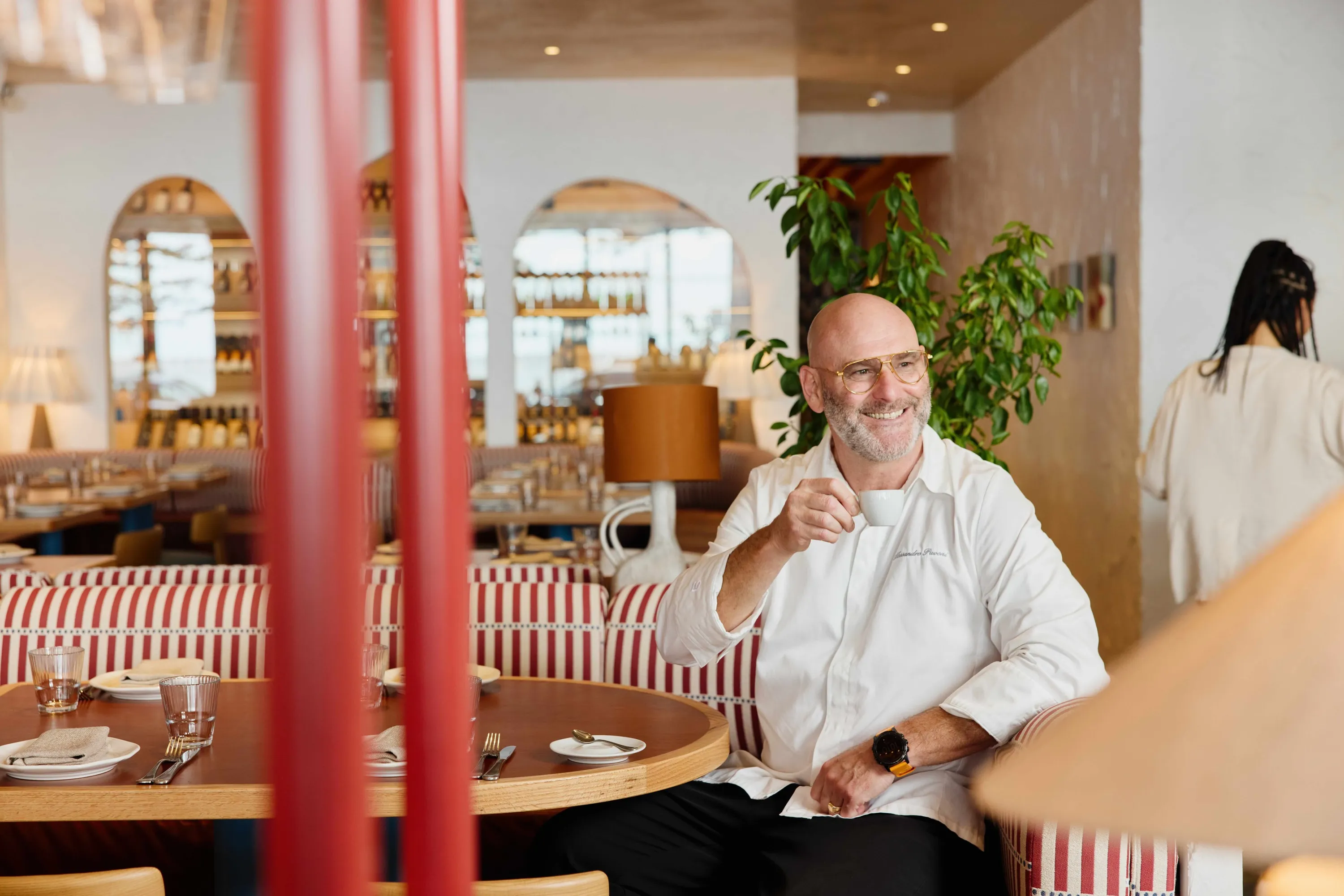 Man holding coffee sitting in restaurant
