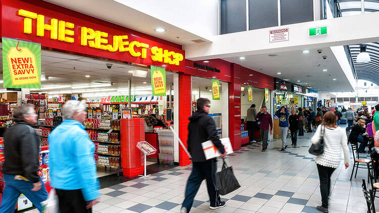 Shoppers walking past The Reject Shop
