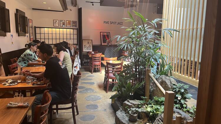 Back room of Hi-Collar with bamboo trees and a rock garden