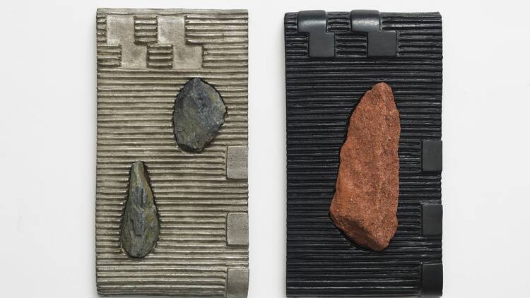 Black and grey tiles with rocks in the centre 