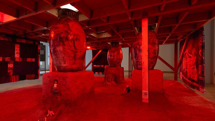 A hellish red landscape with stone towers and miniature creatures below A hellish red landscape with stone towers and miniature creatures below