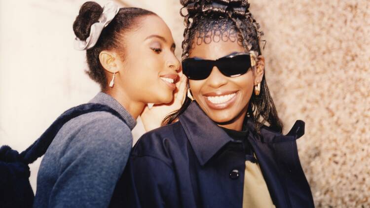 Two Black women, one wearing sunglasses, photographed by Jennie Baptiste 