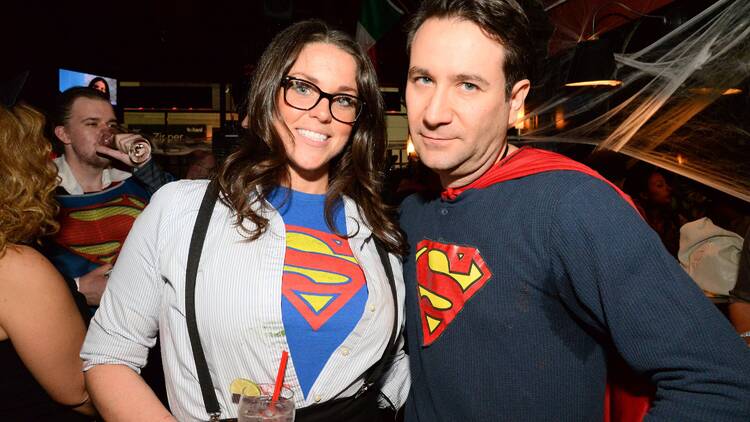 A man and woman dressed in superman gear