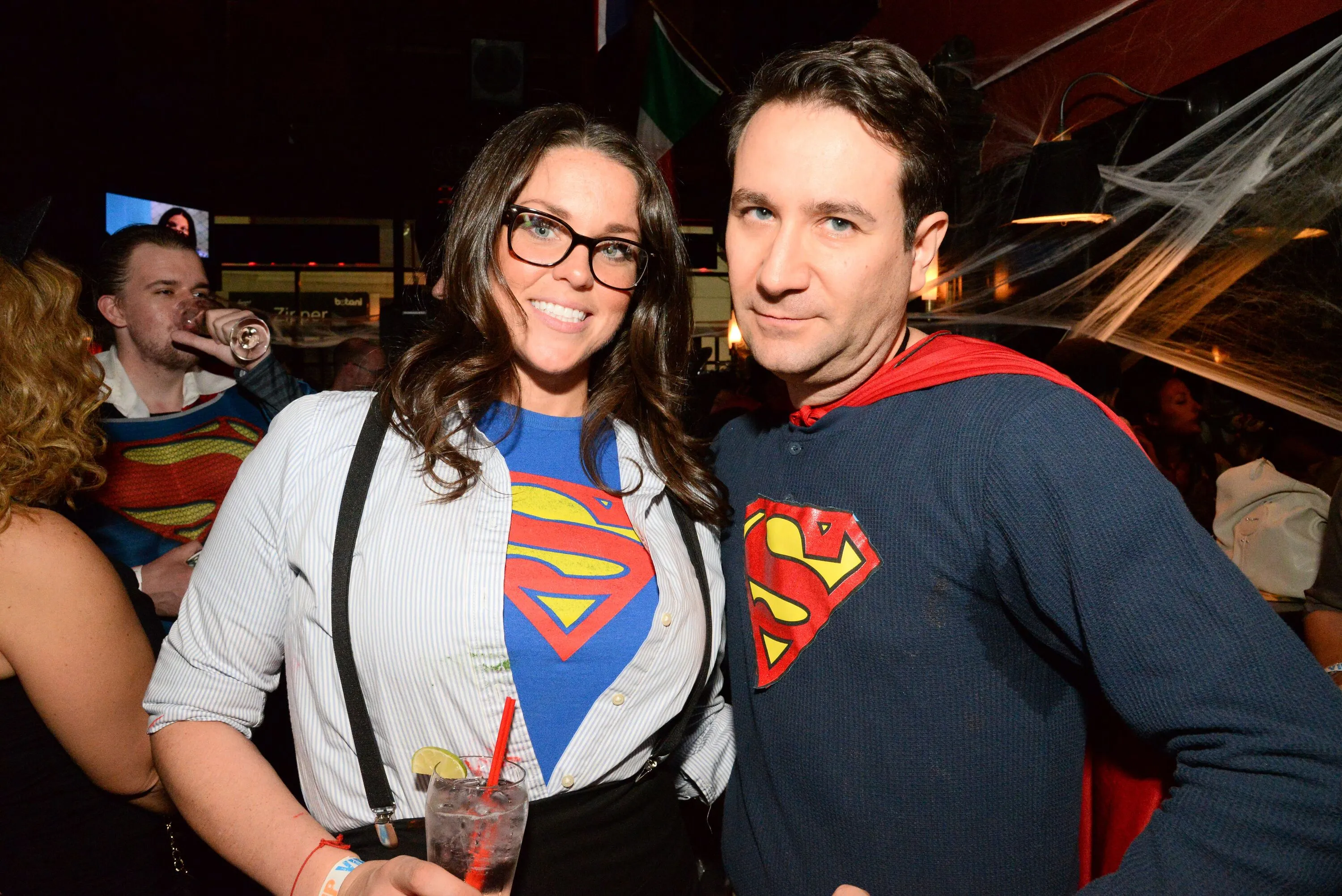 A man and woman dressed in superman gear