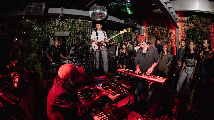 A jazz band playing in an intimate space with a disco ball.