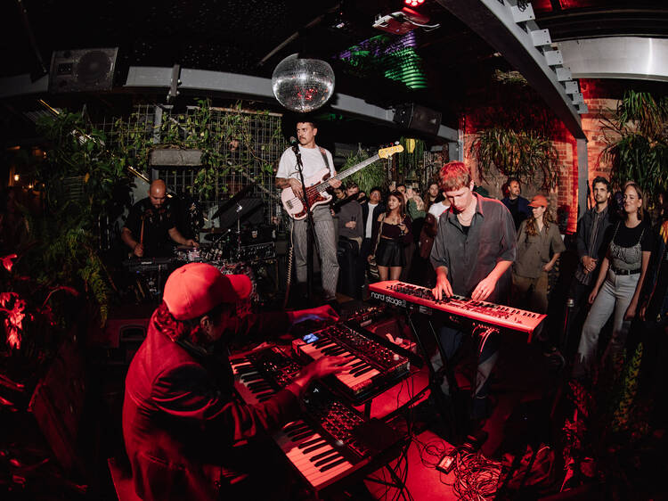 A jazz band playing in an intimate space with a disco ball.