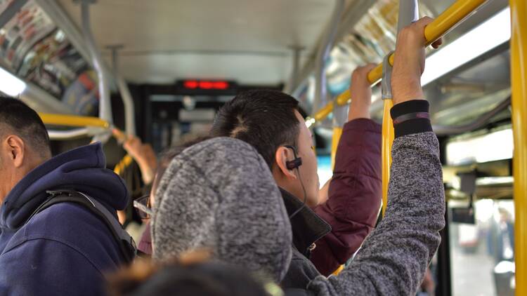 Riders on a crowded NYC bus