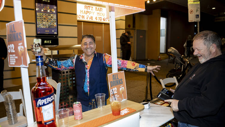 Lively stall owner smiling at a street festival