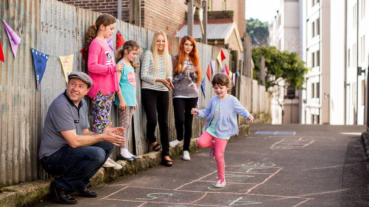 Kids playing hopscotch in Cambridge Street, The Rocks