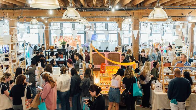 A crowd of shoppers browses the wares at Markets for Makers. 