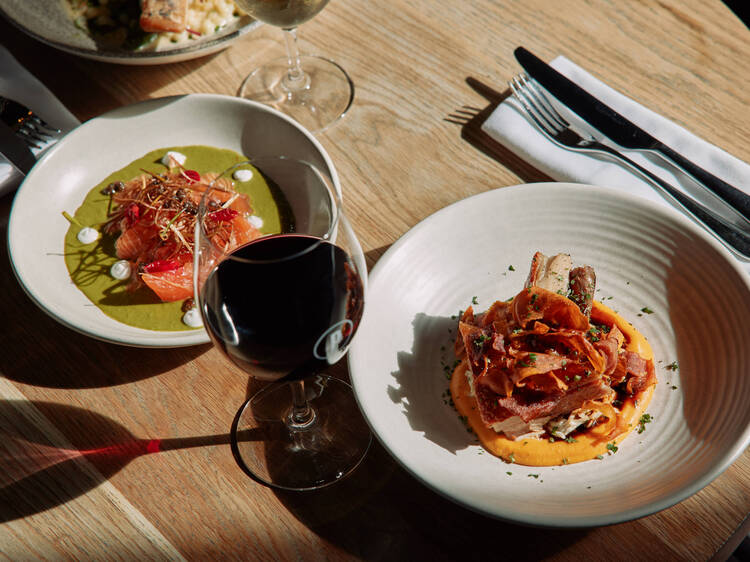 Table set with two plates and red wine glass