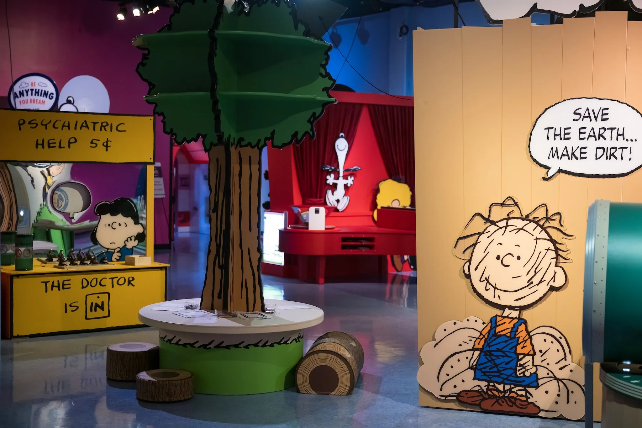 Cutouts of various Peanuts characters and motifs are pictured in a museum.