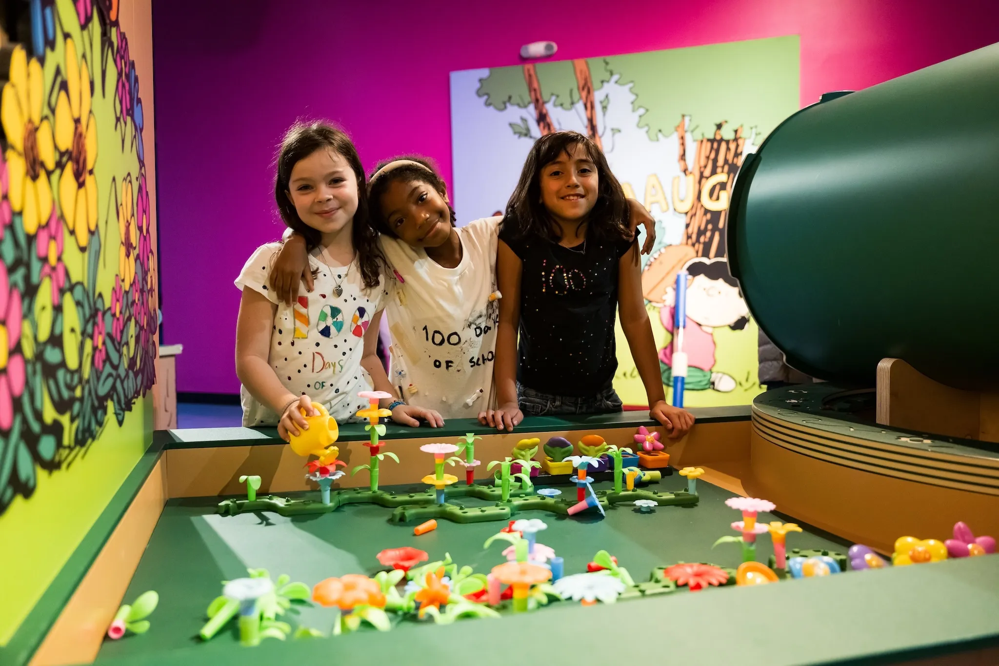 Three children are pictured enjoying the 'Take Care with Peanuts: The Exhibit' Member Preview at the Miami Children's Museum