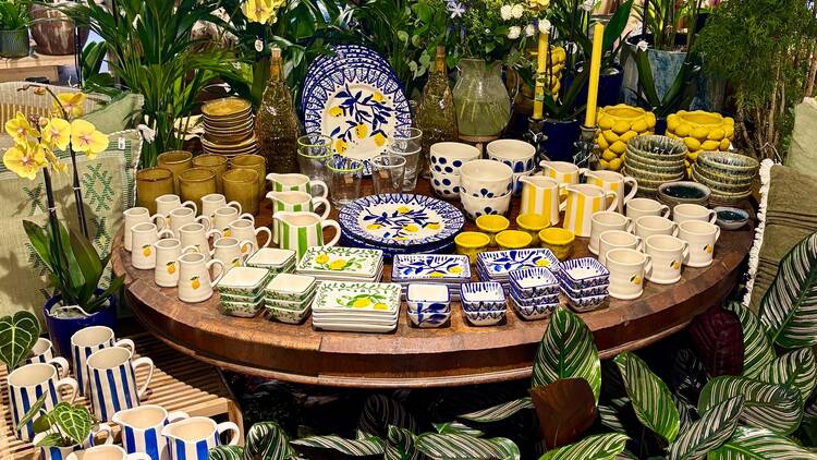 A table filled with ceramics in the midst of plants on sale at The Nunhead Gardener, Camberwell