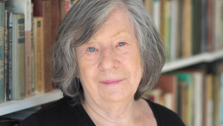 Headshot of filmmaker and theorist Laura Mulvey in front of a bookshelf