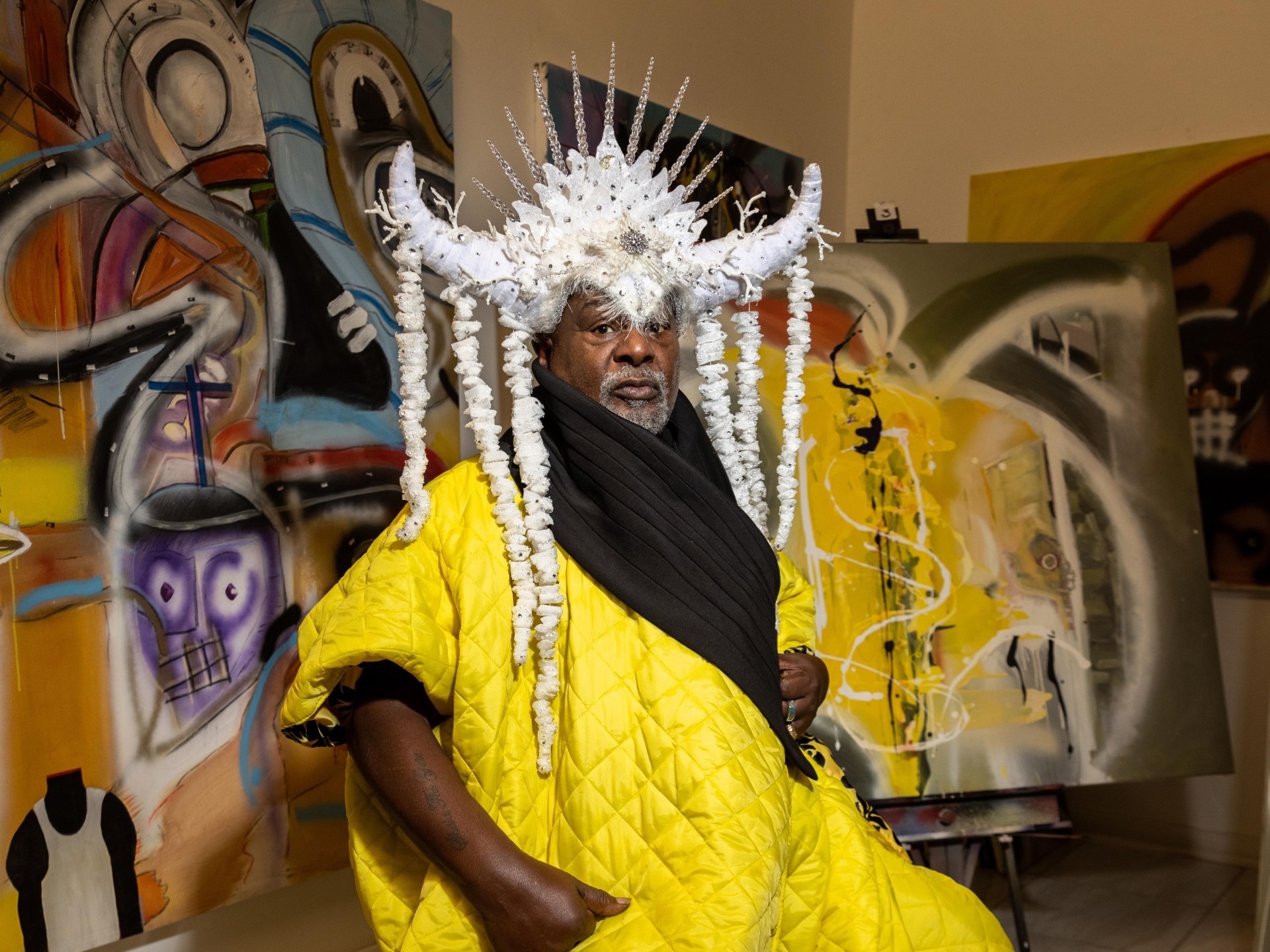 George Clinton in a gallery space surrounded by artworks and wearing an Afrofuturism-inspired costume