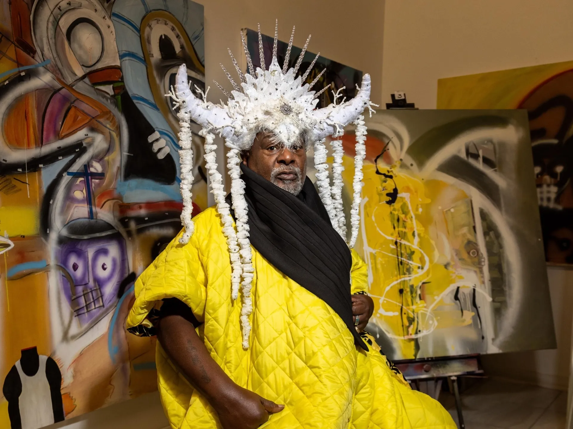 George Clinton in a gallery space surrounded by artworks and wearing an Afrofuturism-inspired costume