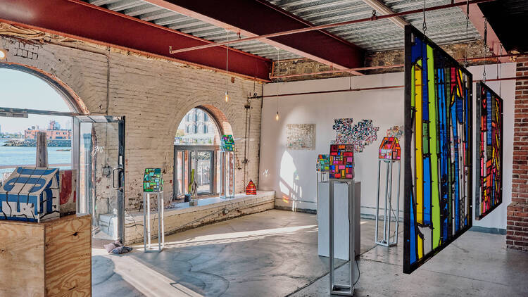 Brightly colored panels and art installations in a warehouse space.