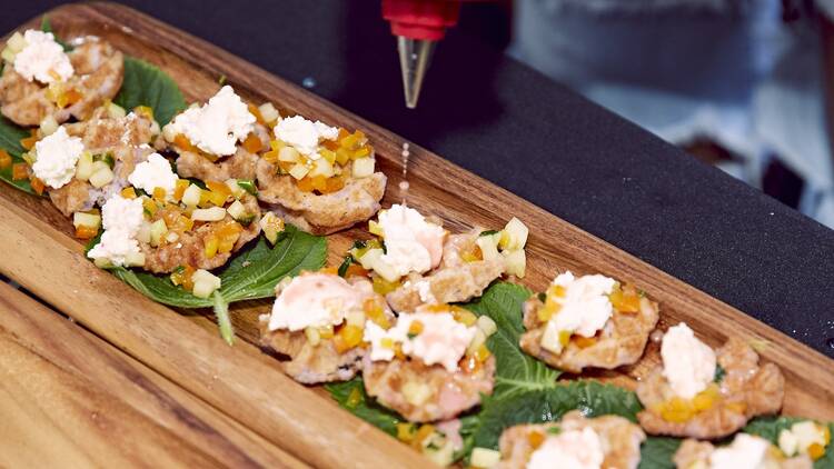 A wooden board with shrimp