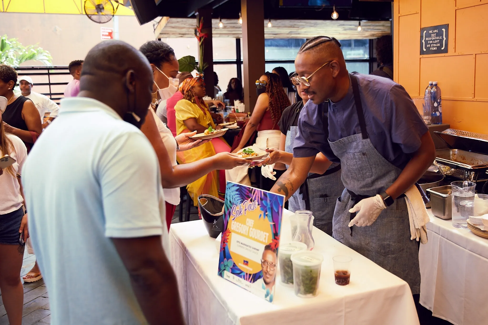 Gregory Gourdet serving guests at Creole Food Festival
