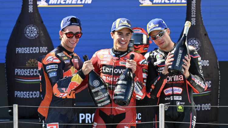 MotoGP winners holding Prosecco bottles
