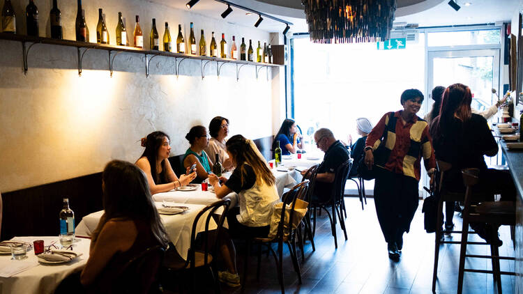 People eating at tables at Belly Bistro
