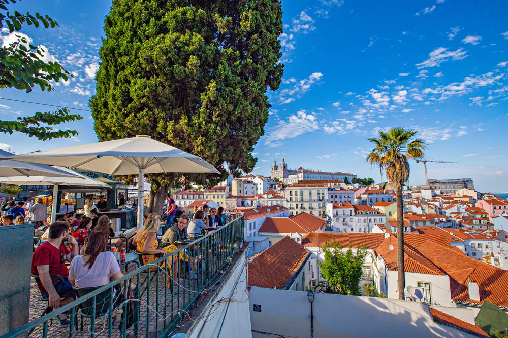 People eating looking out over rooftops in Lisbon