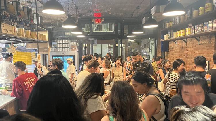 A crowds of people inside L'Industrie Pizza in the West Village