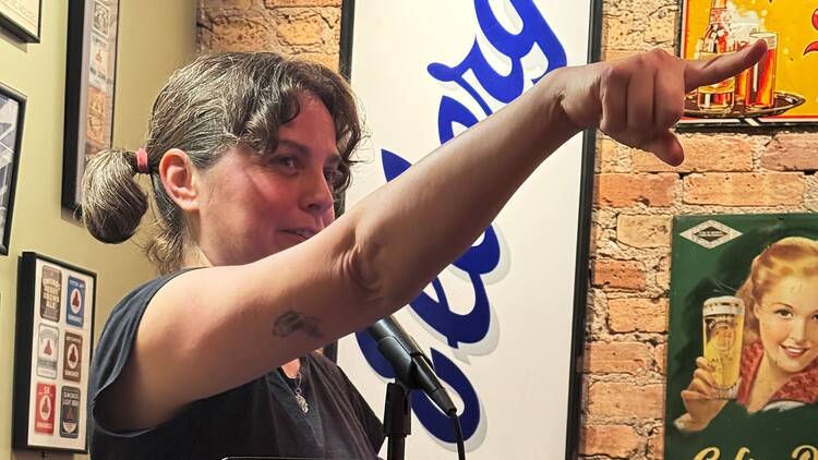 A Tuesday Funk reader points at the unseen audience. A Tuesday Funk reader points at the unseen audience.