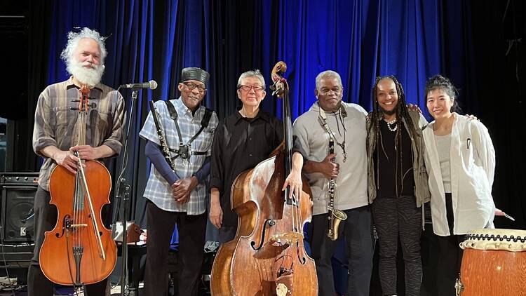 A six-piece band poses for a group photo. A six-piece band poses for a group photo.