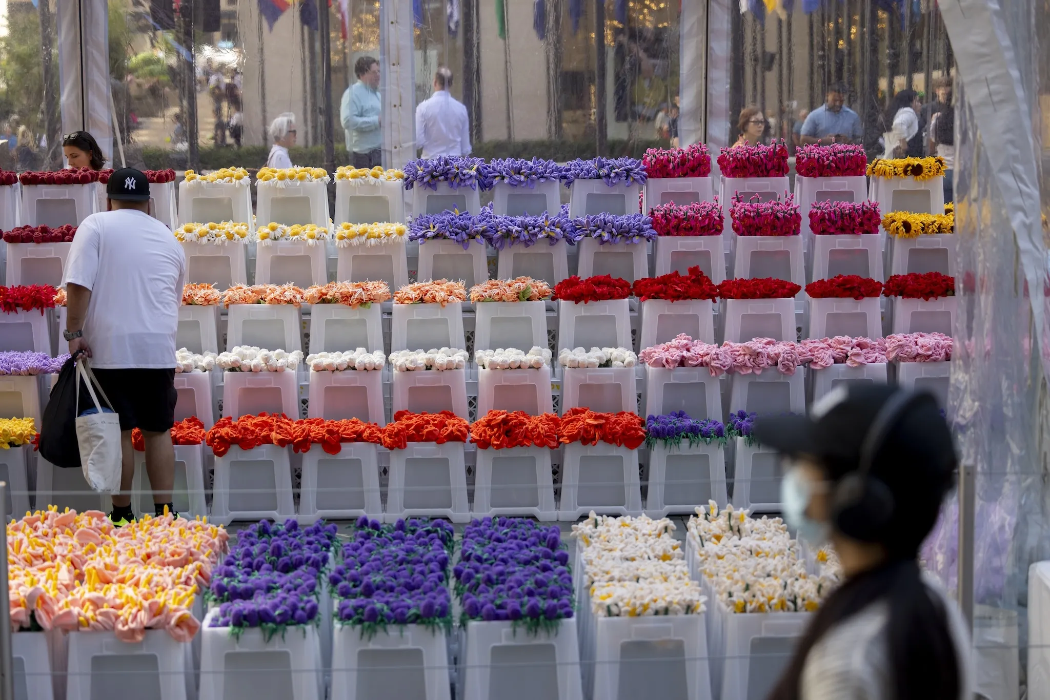 People shop for flowers from a flower market.