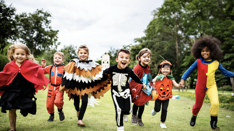 Kids running in Halloween costumes