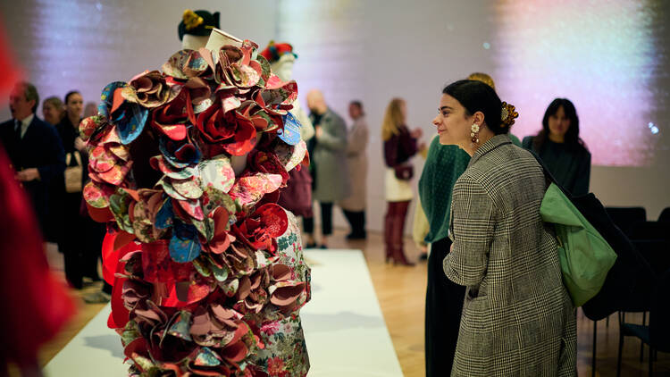 A person looking a 'petal dress' at the NGV.
