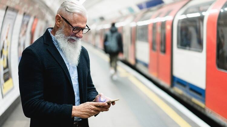 Man with phone on London Underground