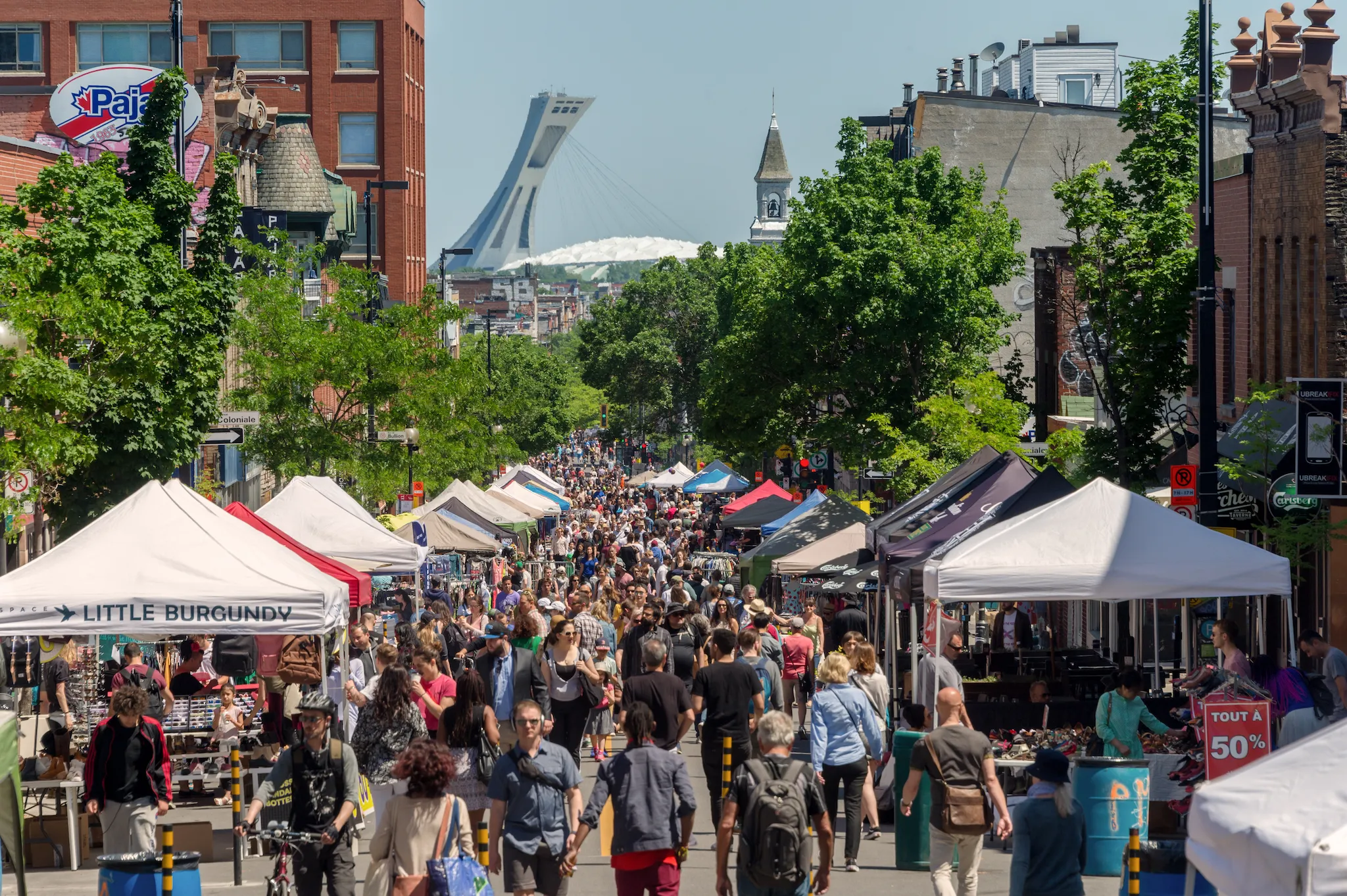 Summer sidewalk sale with crowds of people on Mont-Royal Avenue, Montreal, Canada